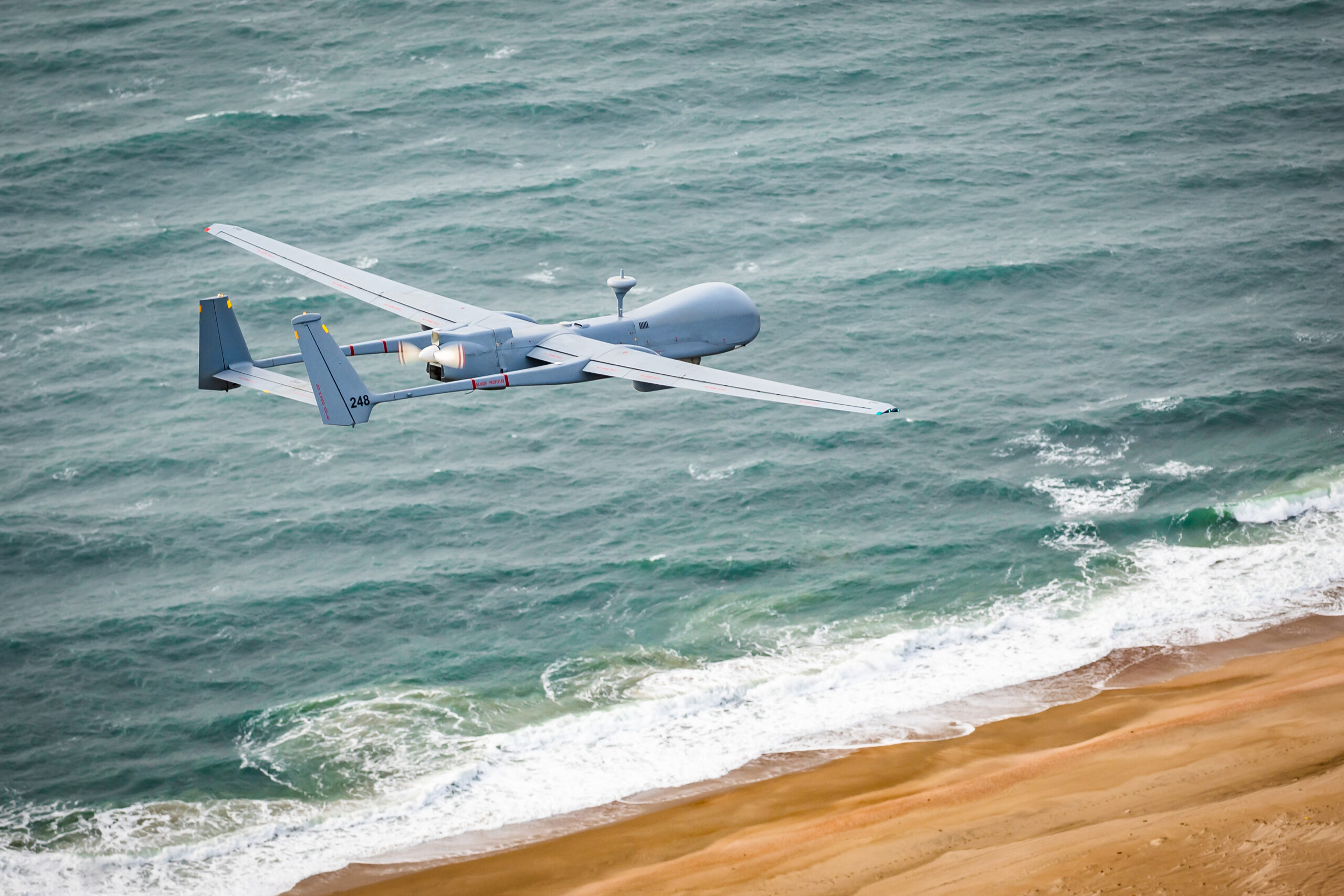 An airplane flying above the sea, representing IAI North America's aerospace capabilities